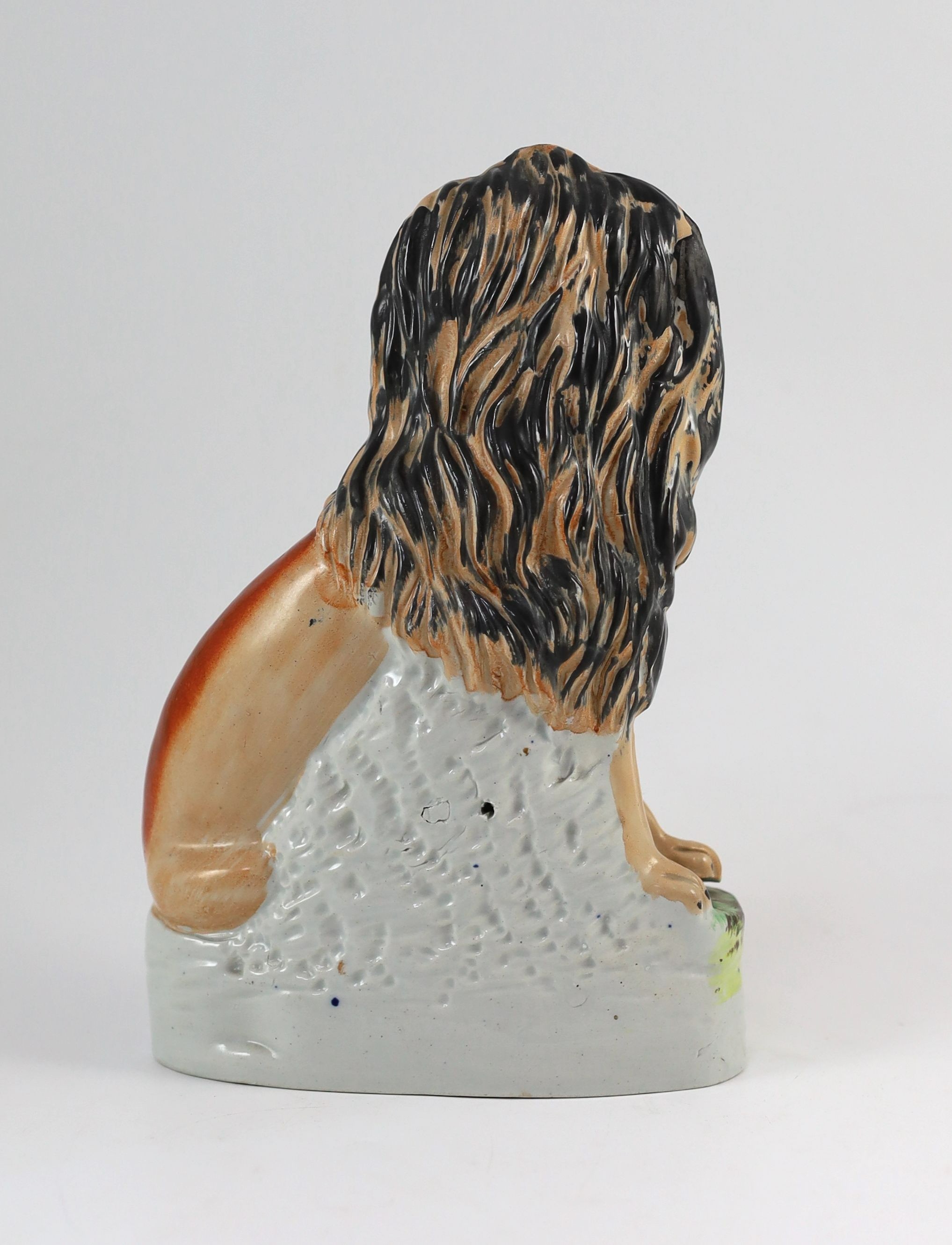 A Staffordshire ‘lion and lamb’ group, mid 19th century, Height 26cm.